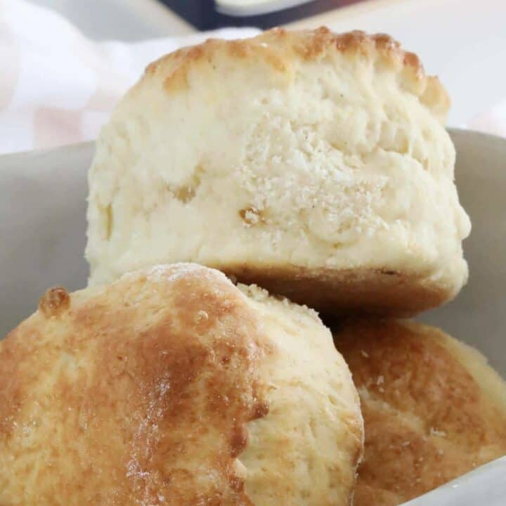 A bowl filled with big fluffy scones.