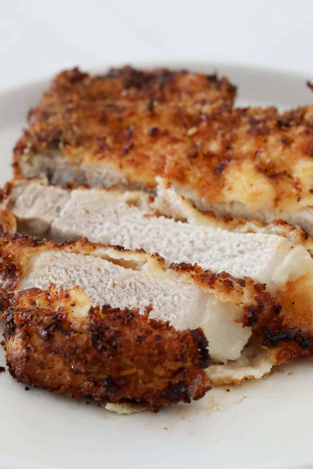The cooked pork chop cut into pieces to show the cooked pork.