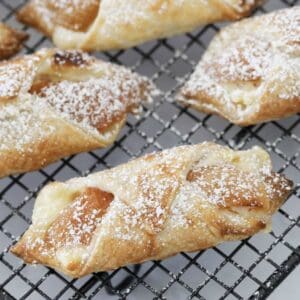 Flakey apricot danishes sprinkled with icing sugar.