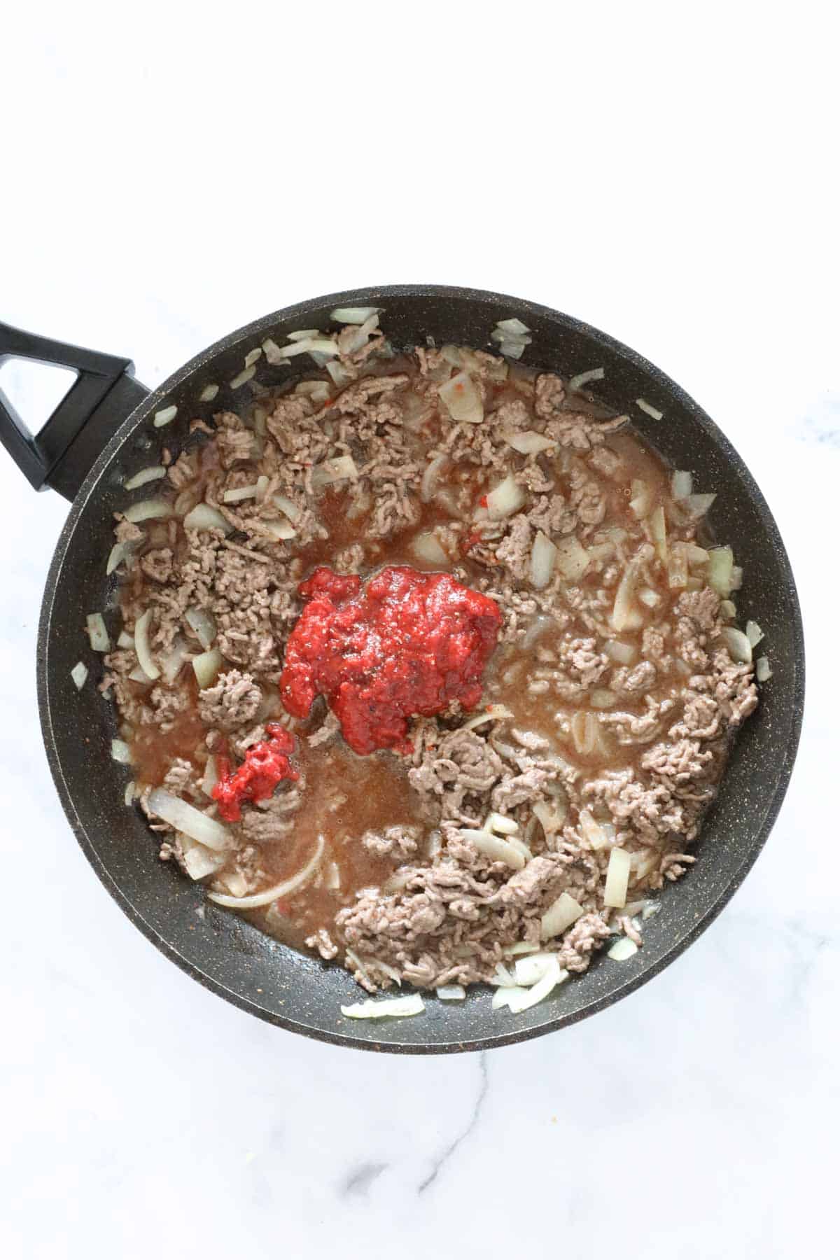 Tomato paste, Worcestershire sauce and liquid beef stock added to the mince.