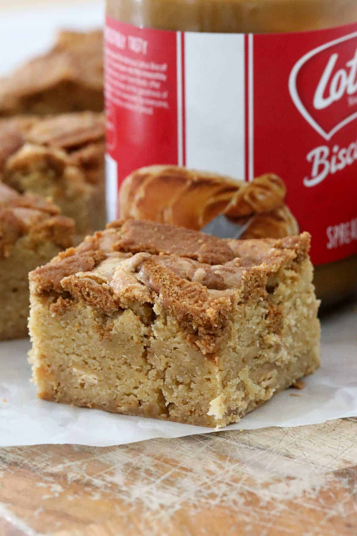 A close up of a square of Biscoff Blondie with a chunk of cookie on top.