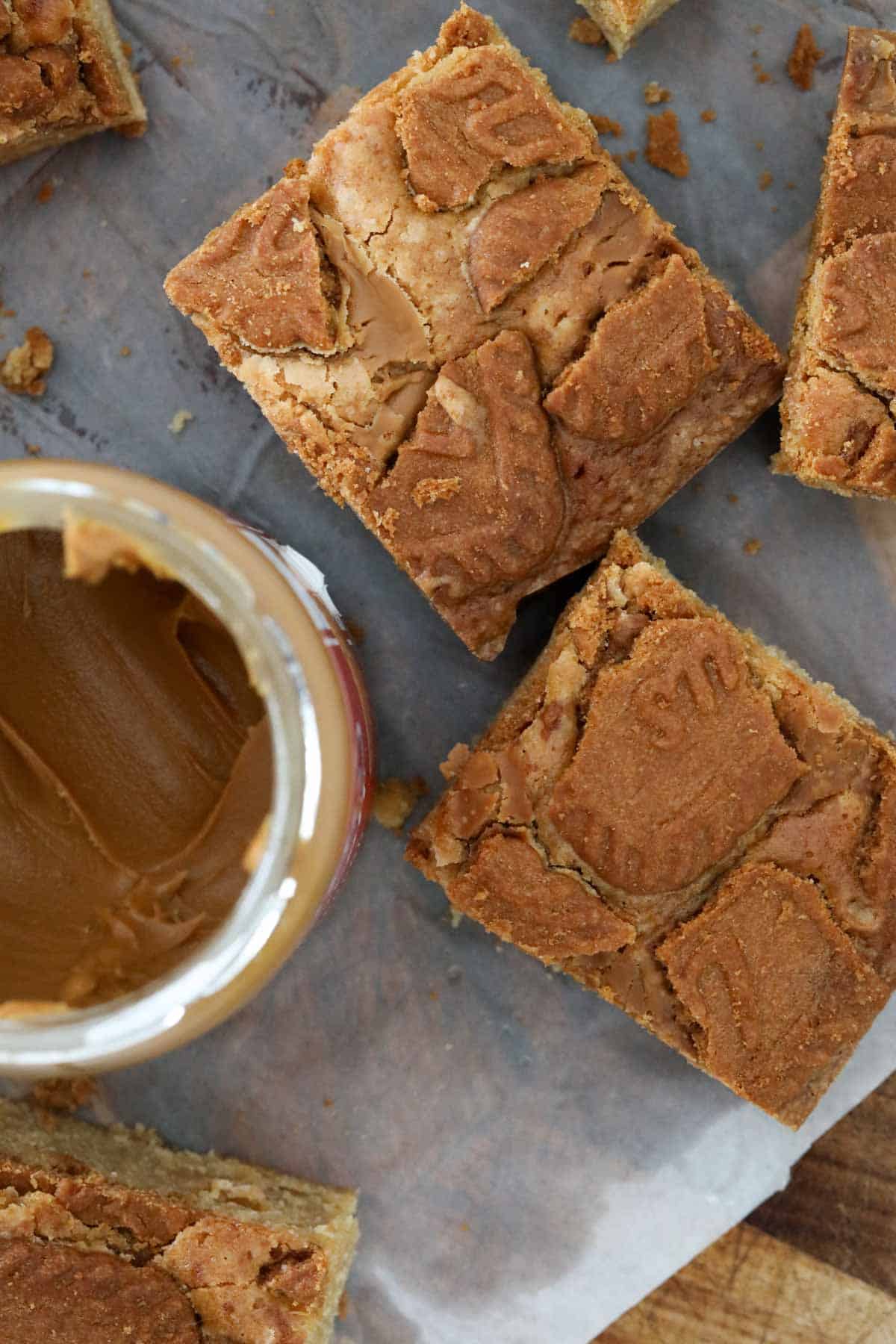 An overhead shot showing crunchy chunks of biscuit on top of Biscoff blondies.