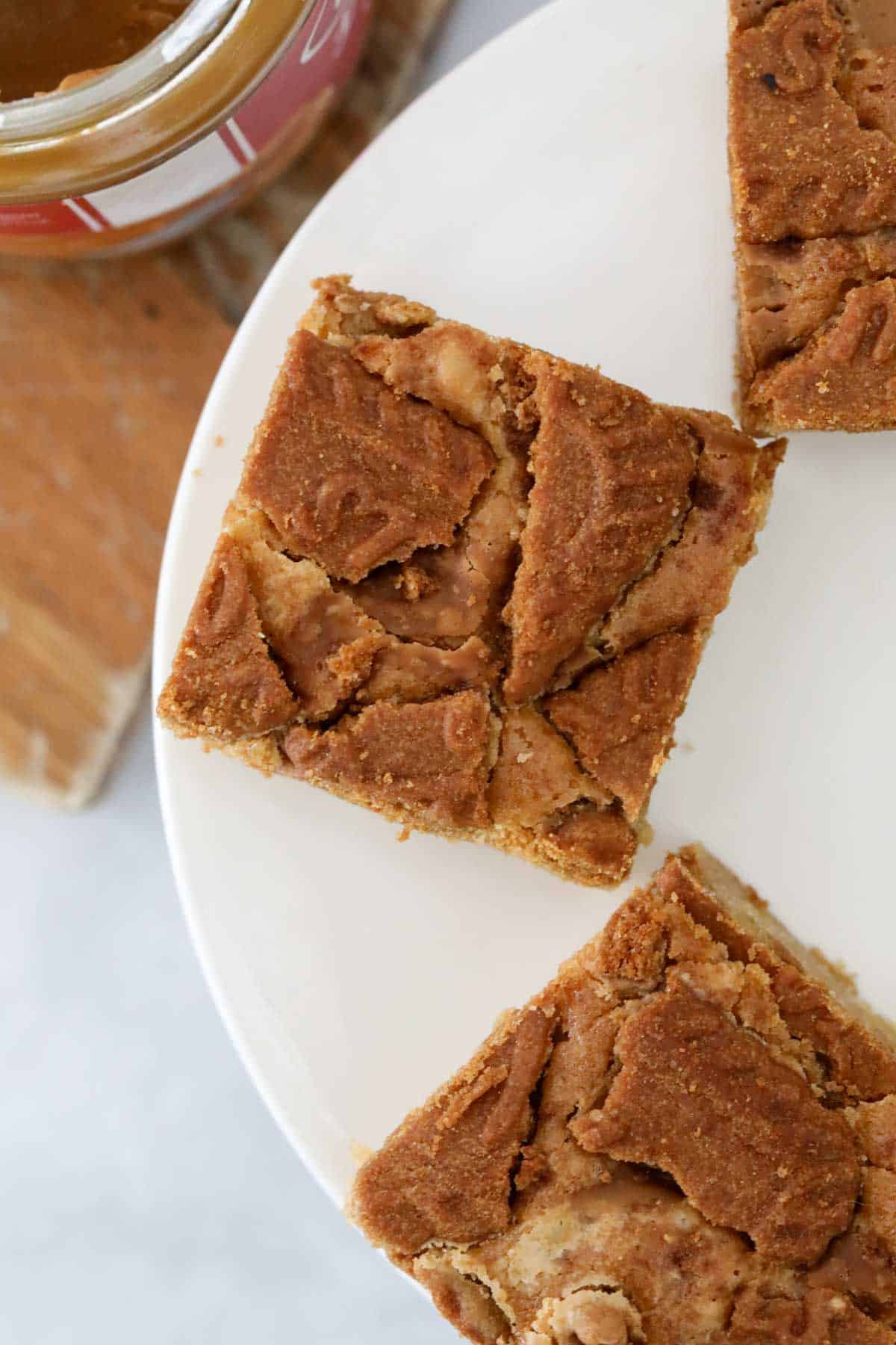 Looking down on Biscoff blondie squares on a cake stand.