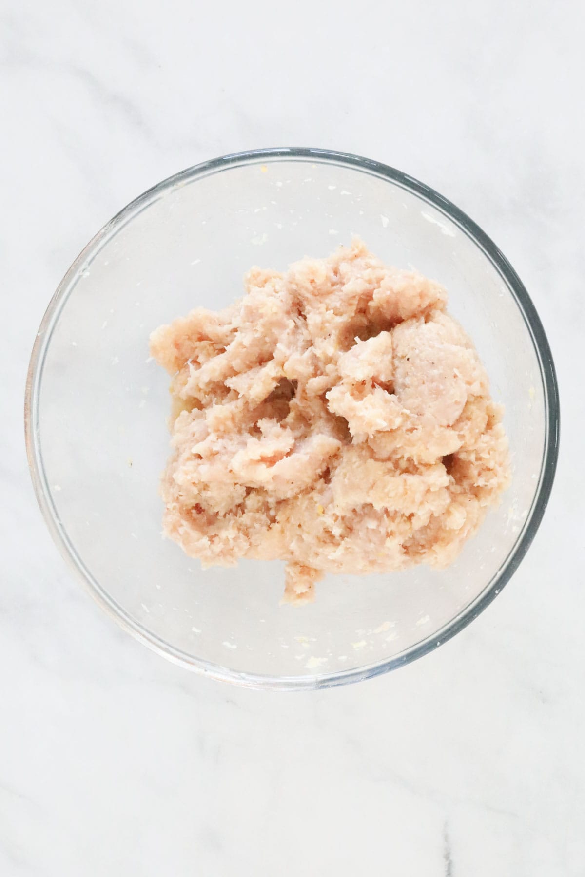 The combined chicken meatball mixture in the mixing bowl.