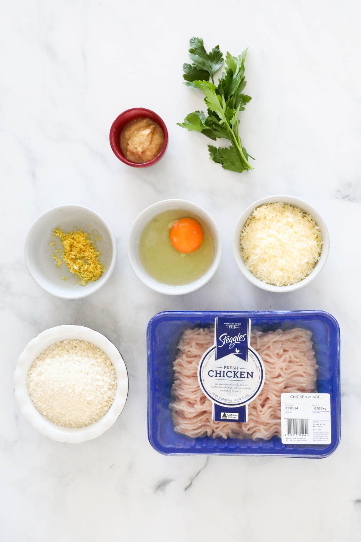 Ingredients for the chicken meatballs weighed out and placed in individual bowls.