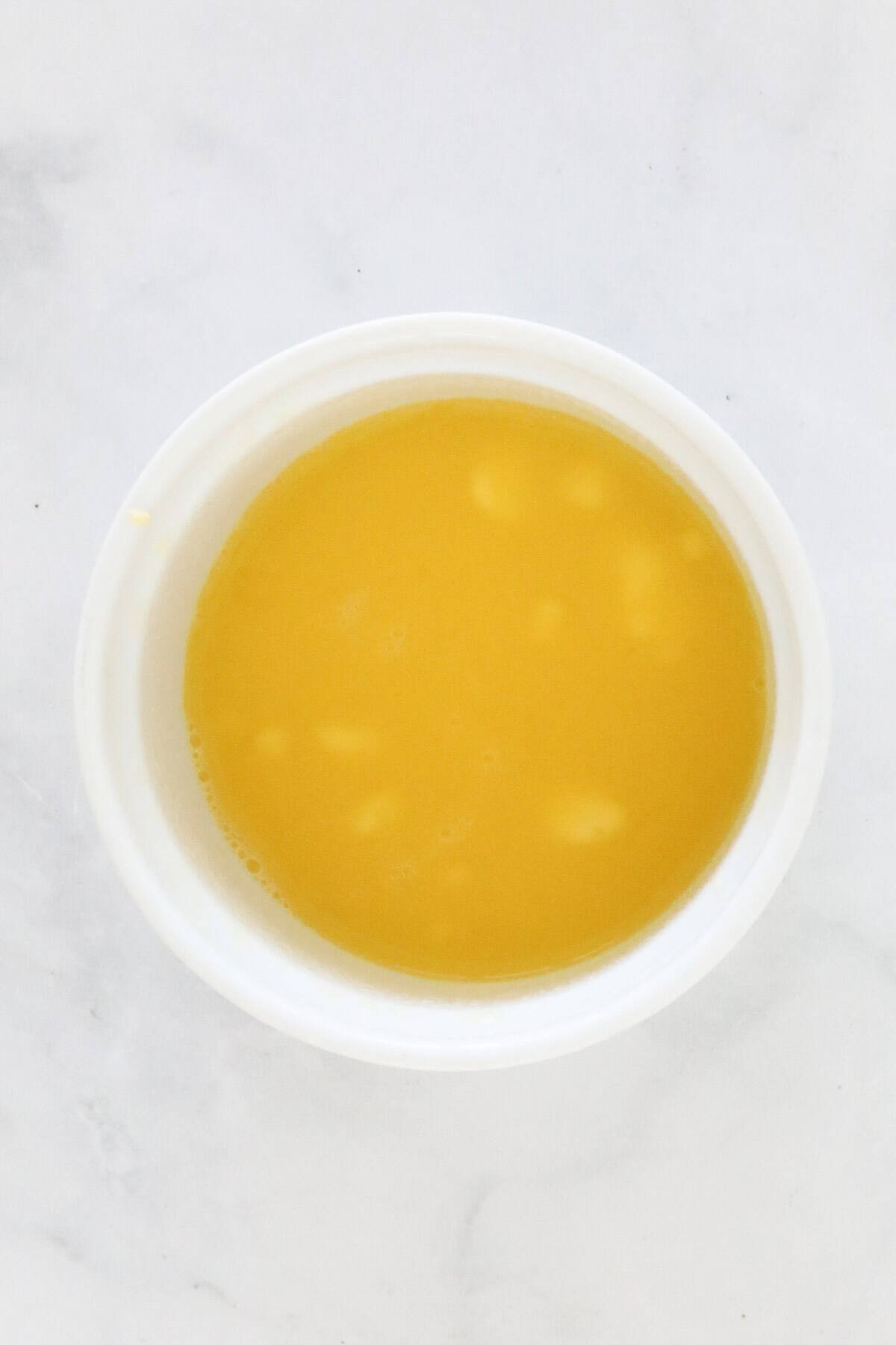 Melted butter in a ramekin.