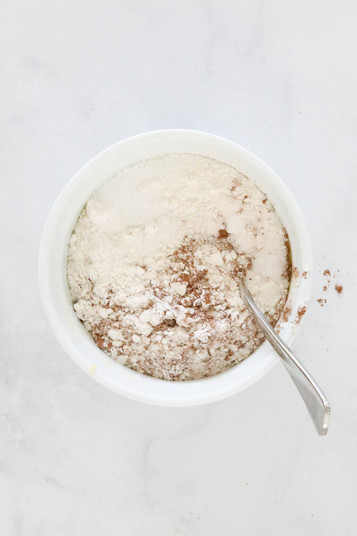 Flour, sugar and cocoa powder added to the melted butter.