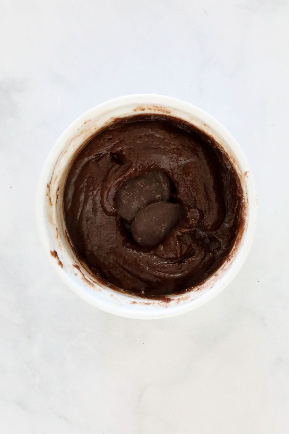 Chocolate melts added to the centre of the mug cake batter.