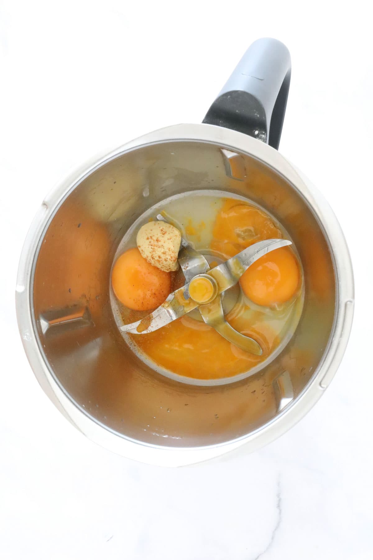 Egg yolks, lemon juice and Dijon mustard in a Thermomix jug.