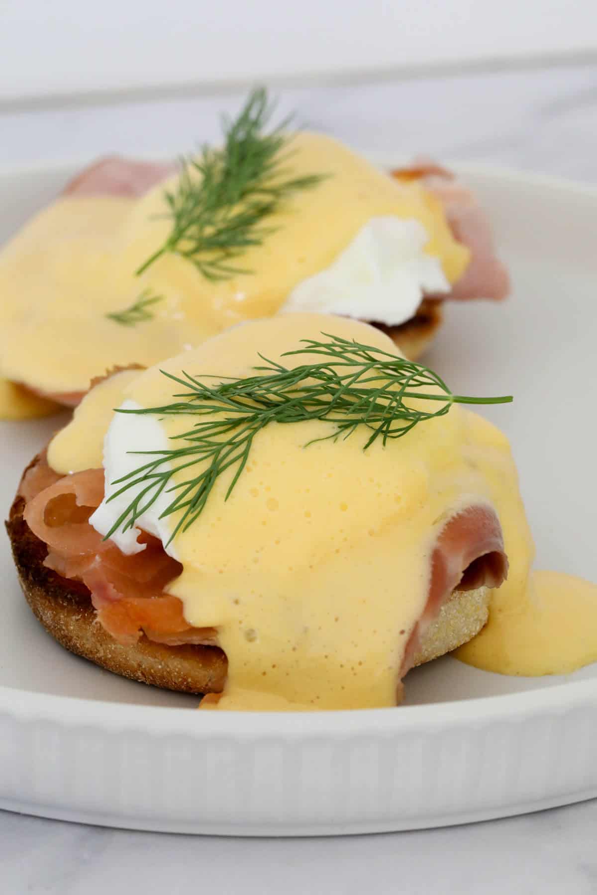 English muffins topped with smoked salmon and hollandaise sauce.