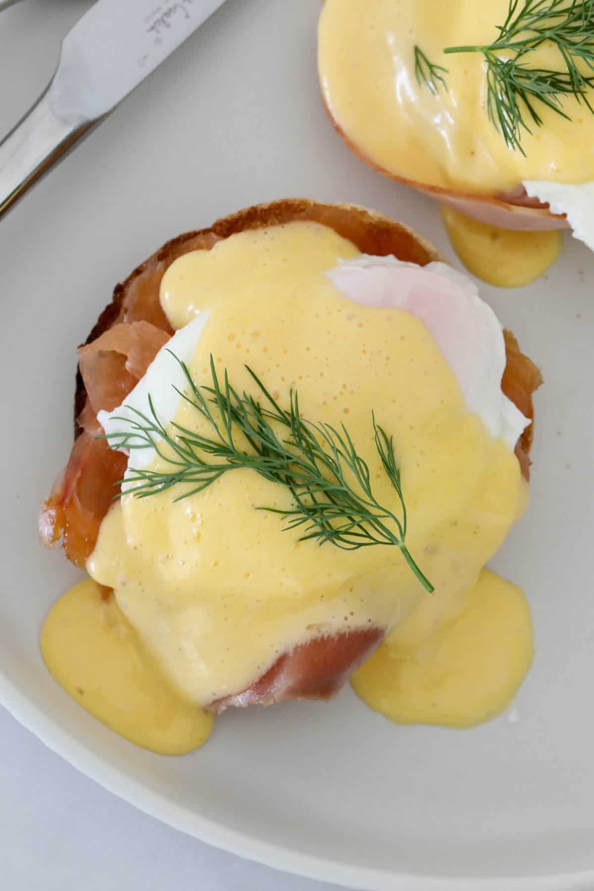 An English muffin with oached egg and smoked salmon topped with hollandaise.