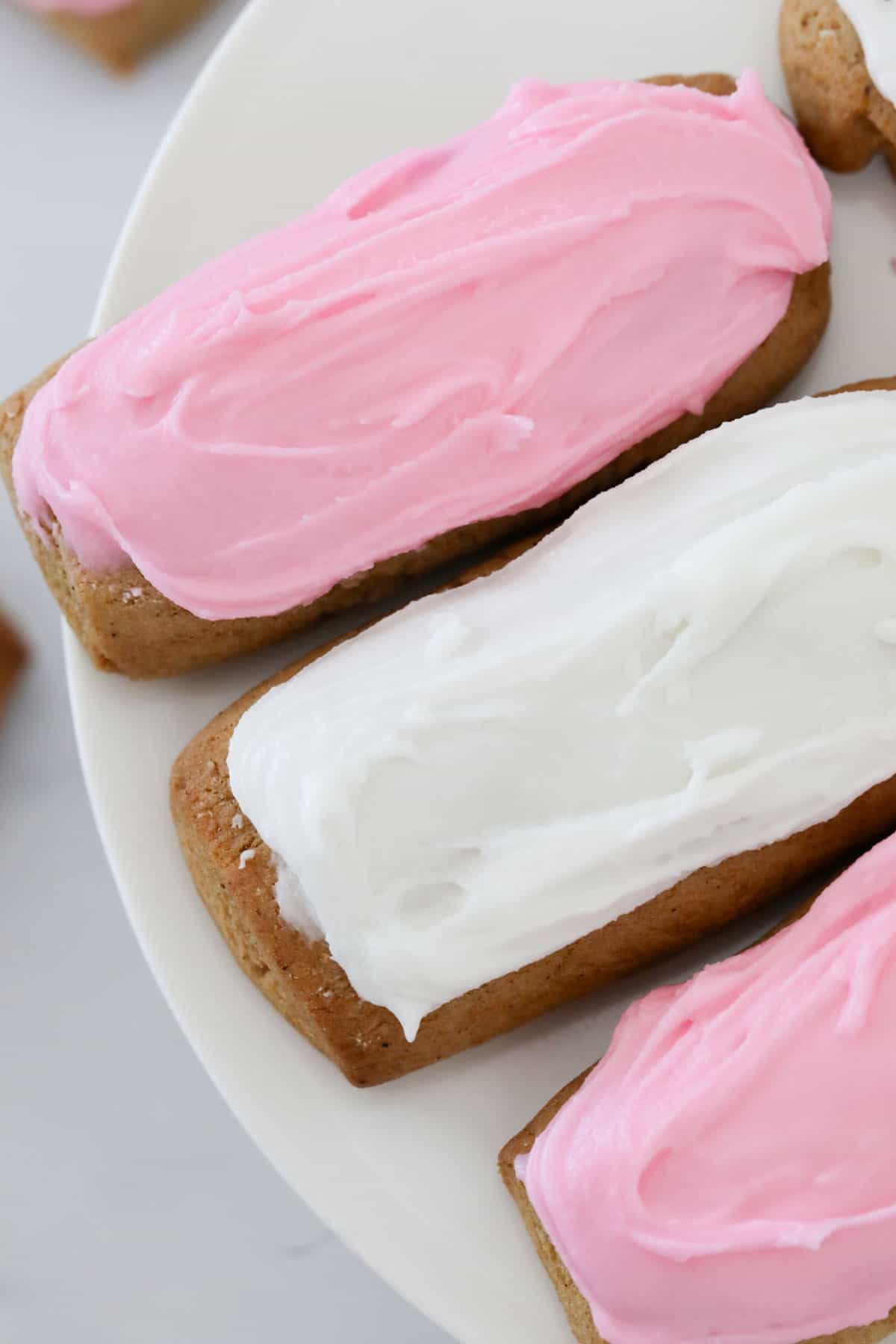 Close up of pink and white spiced biscuits.