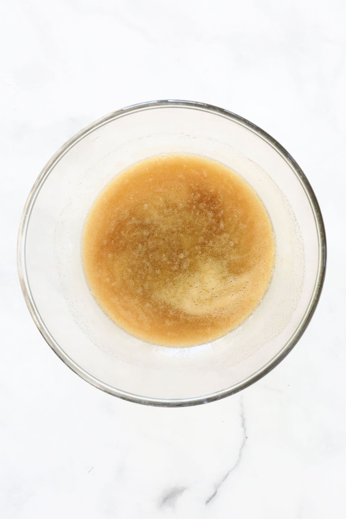 The melted butter honey mixture in a glass bowl.