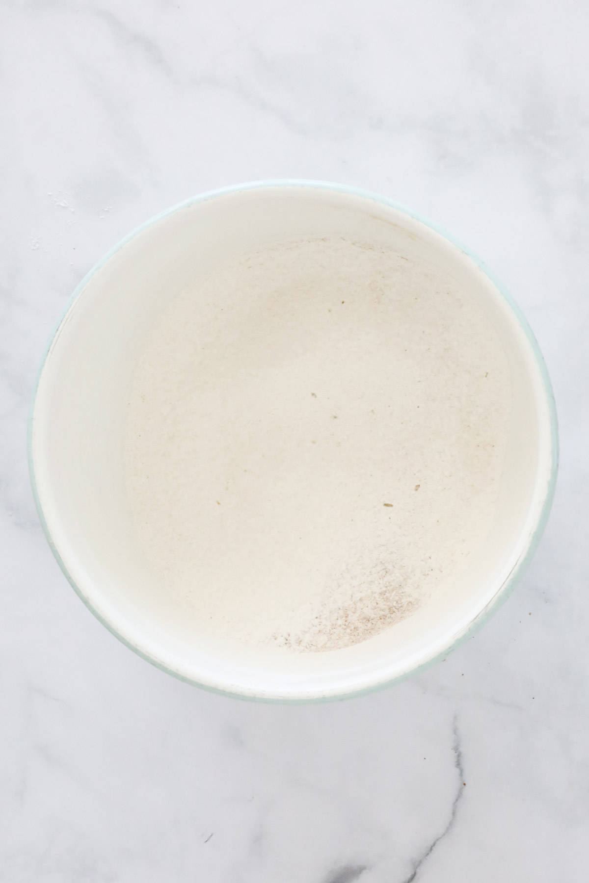 Sifted flour, ginger, bicarb and mixed spice in a bowl.