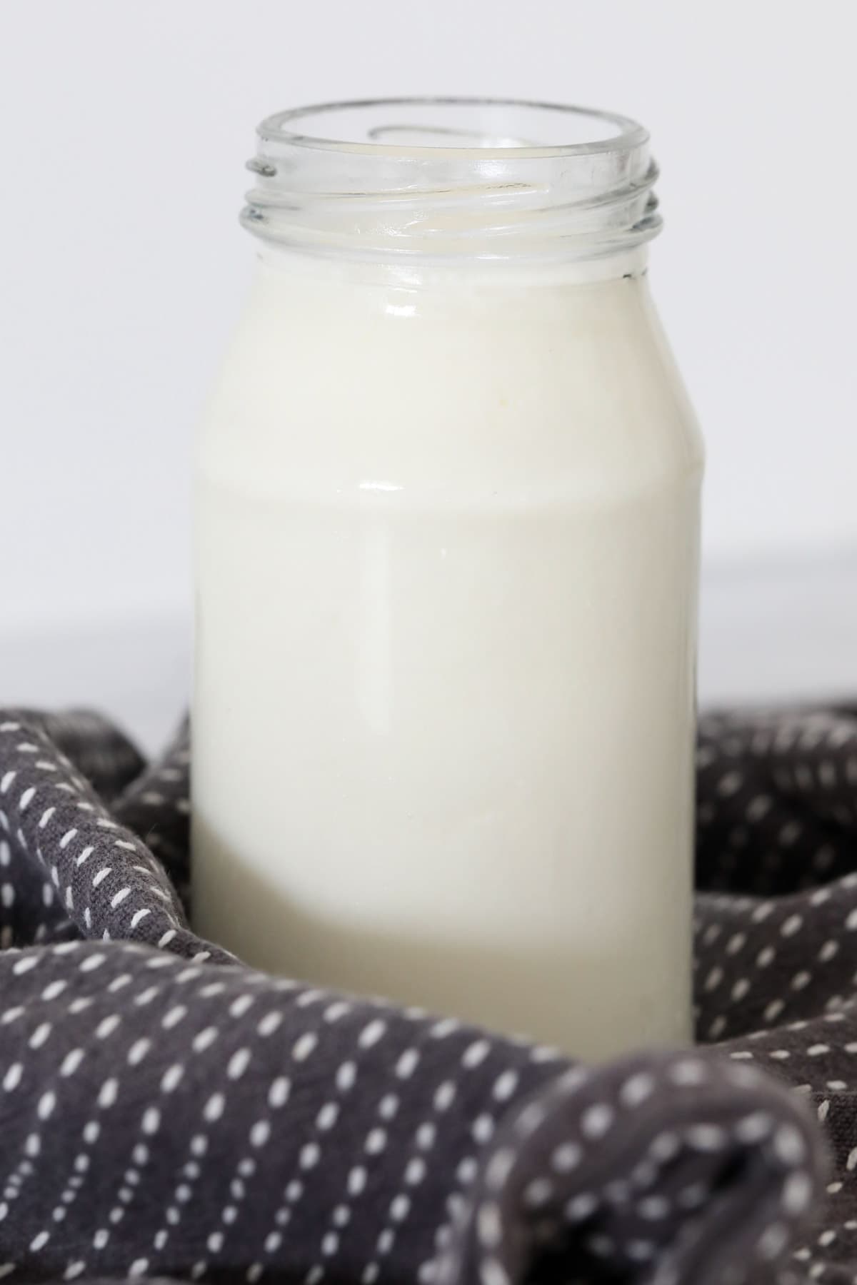 A small bottle filled with buttermilk.