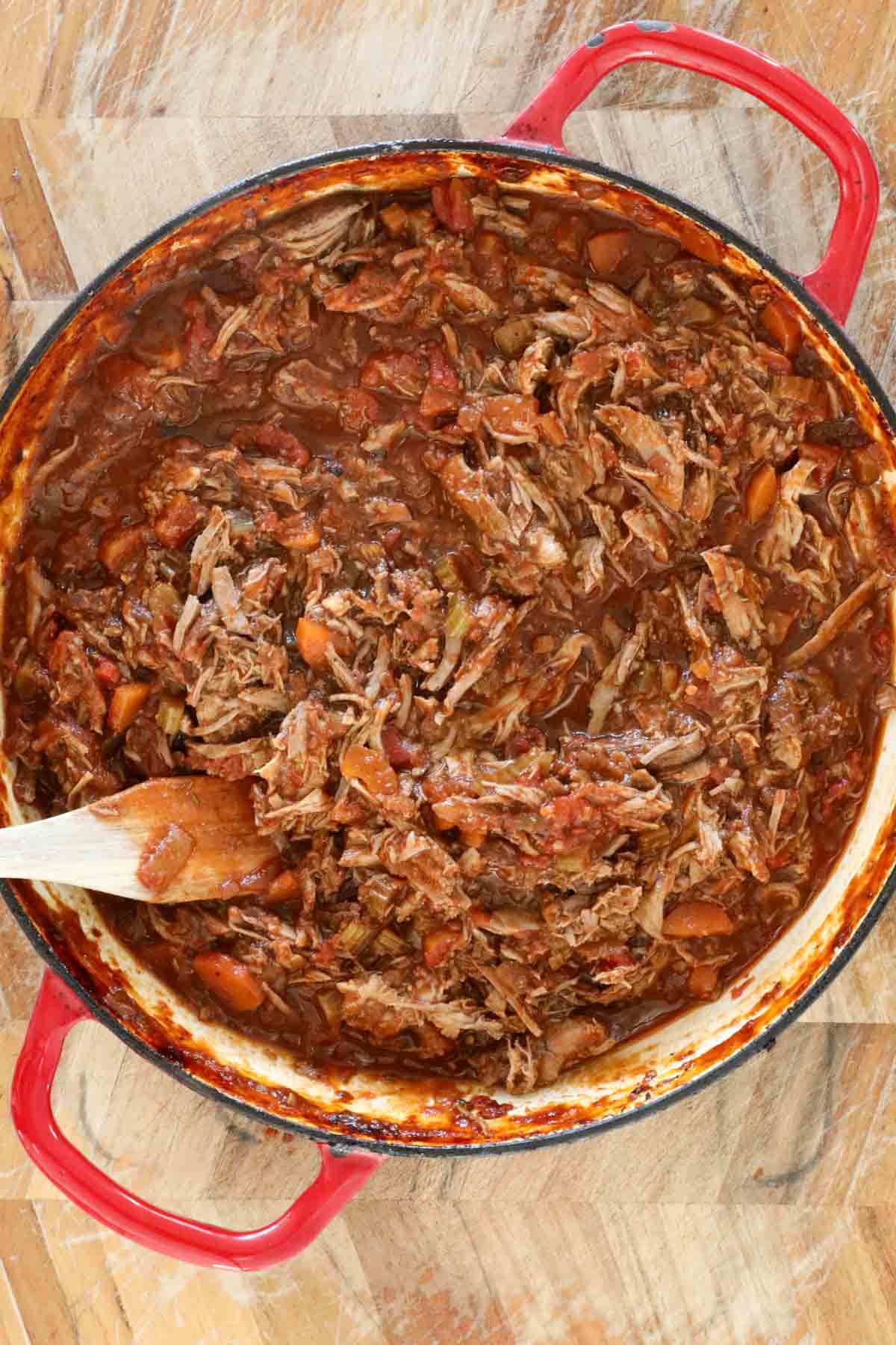 The shredded lamb heated in the sauce ready to serve.