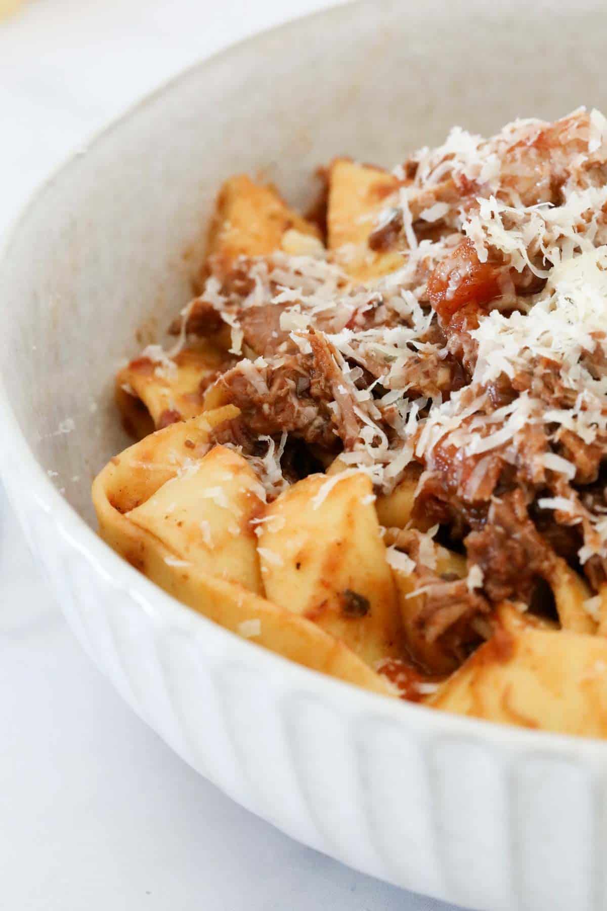 The lamb ragu served with pappardelle pasta and a sprinkle of grated parmesan.