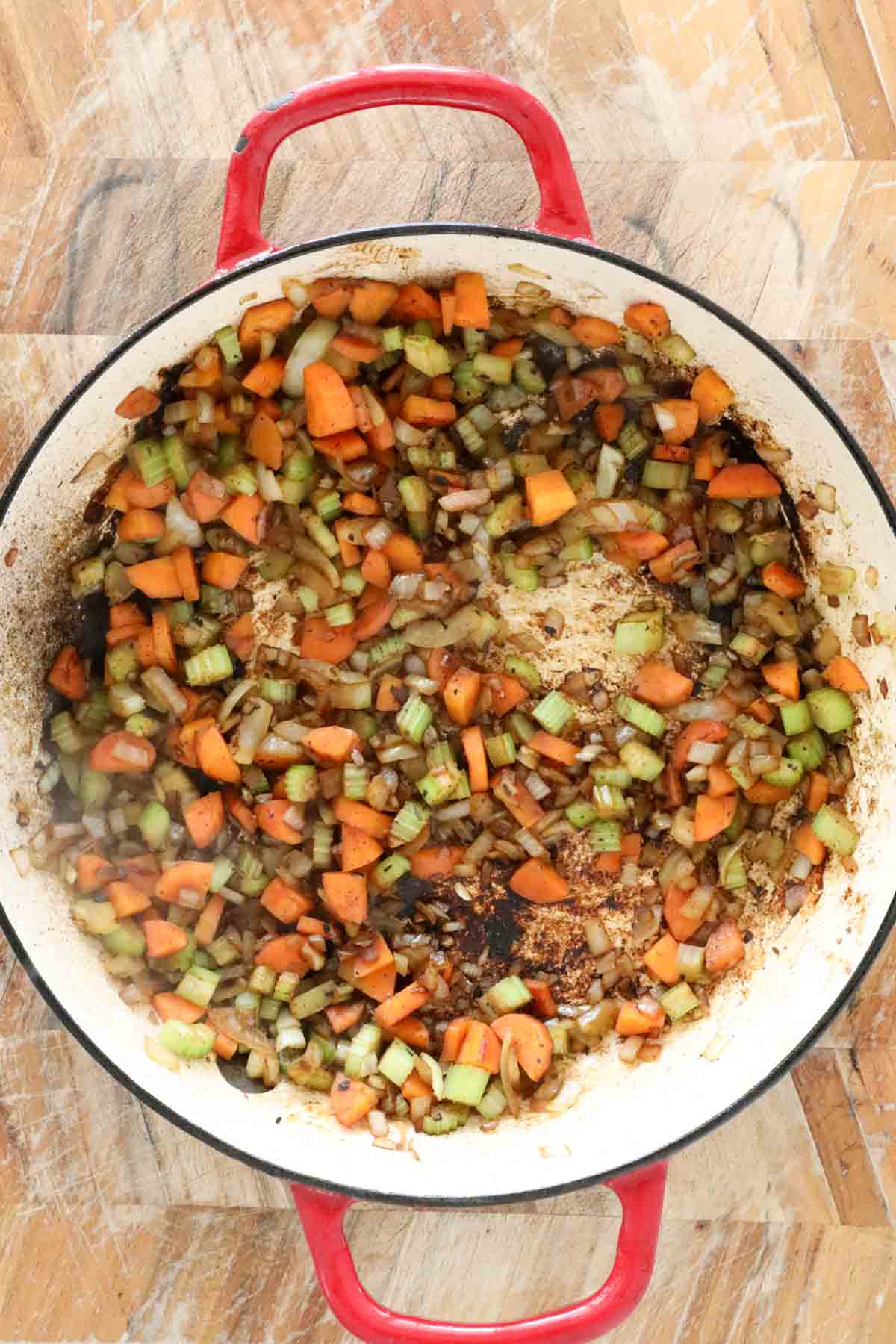 Diced onion, carrot and celery cooking in a pan.