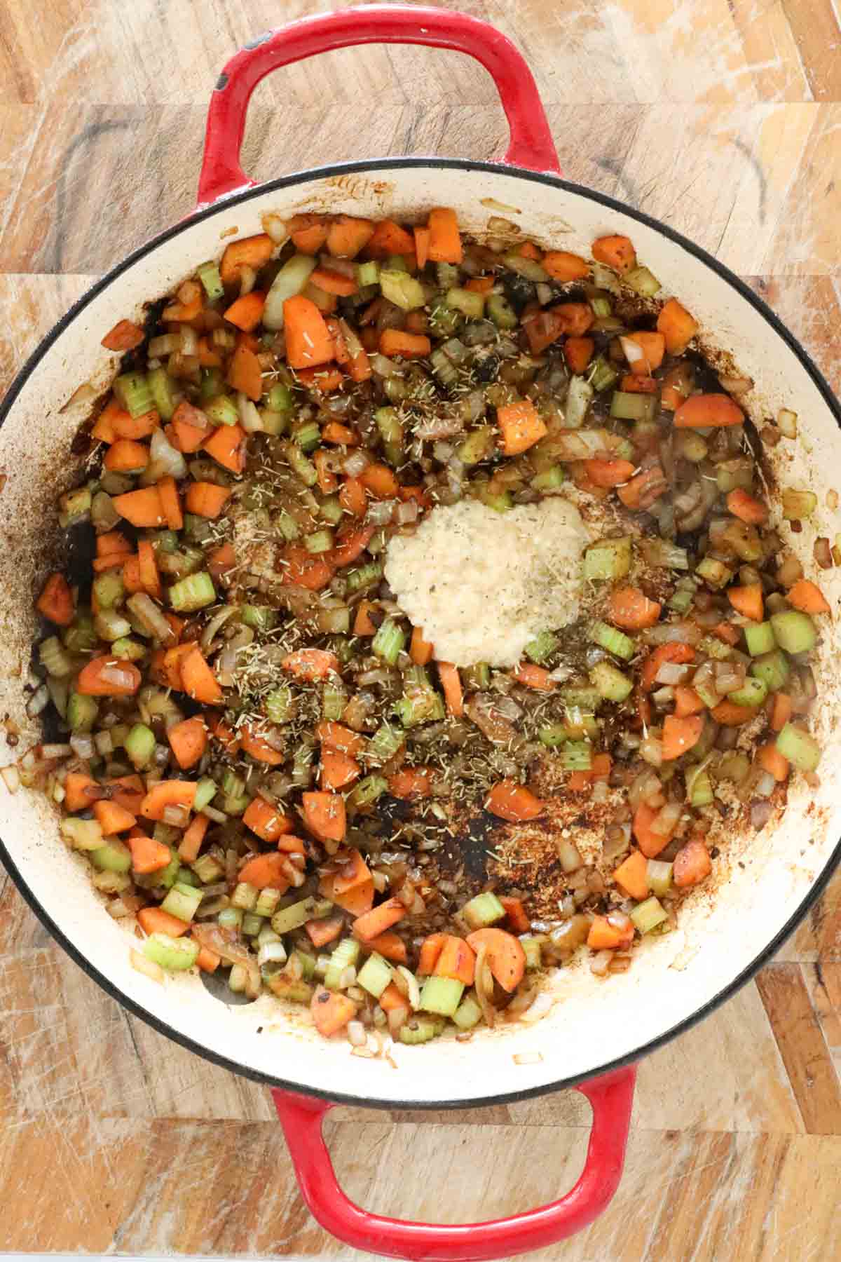 Garlic and thyme added to the cooked diced vegetables.