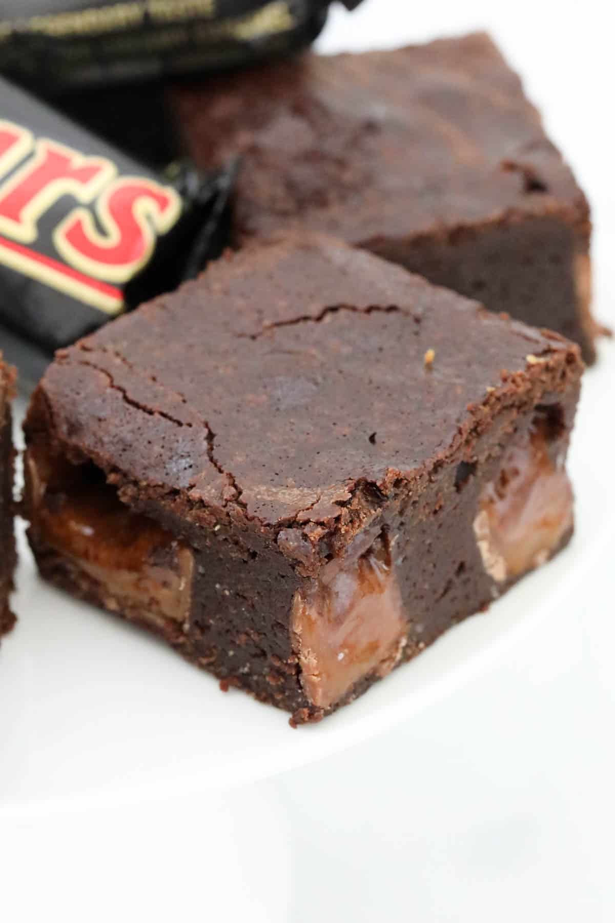 A square of brownie with chunks of Mars bar inside.