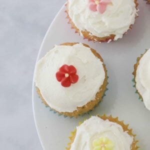 Little mini cupcakes topped with vanilla buttercream and decorative flowers.