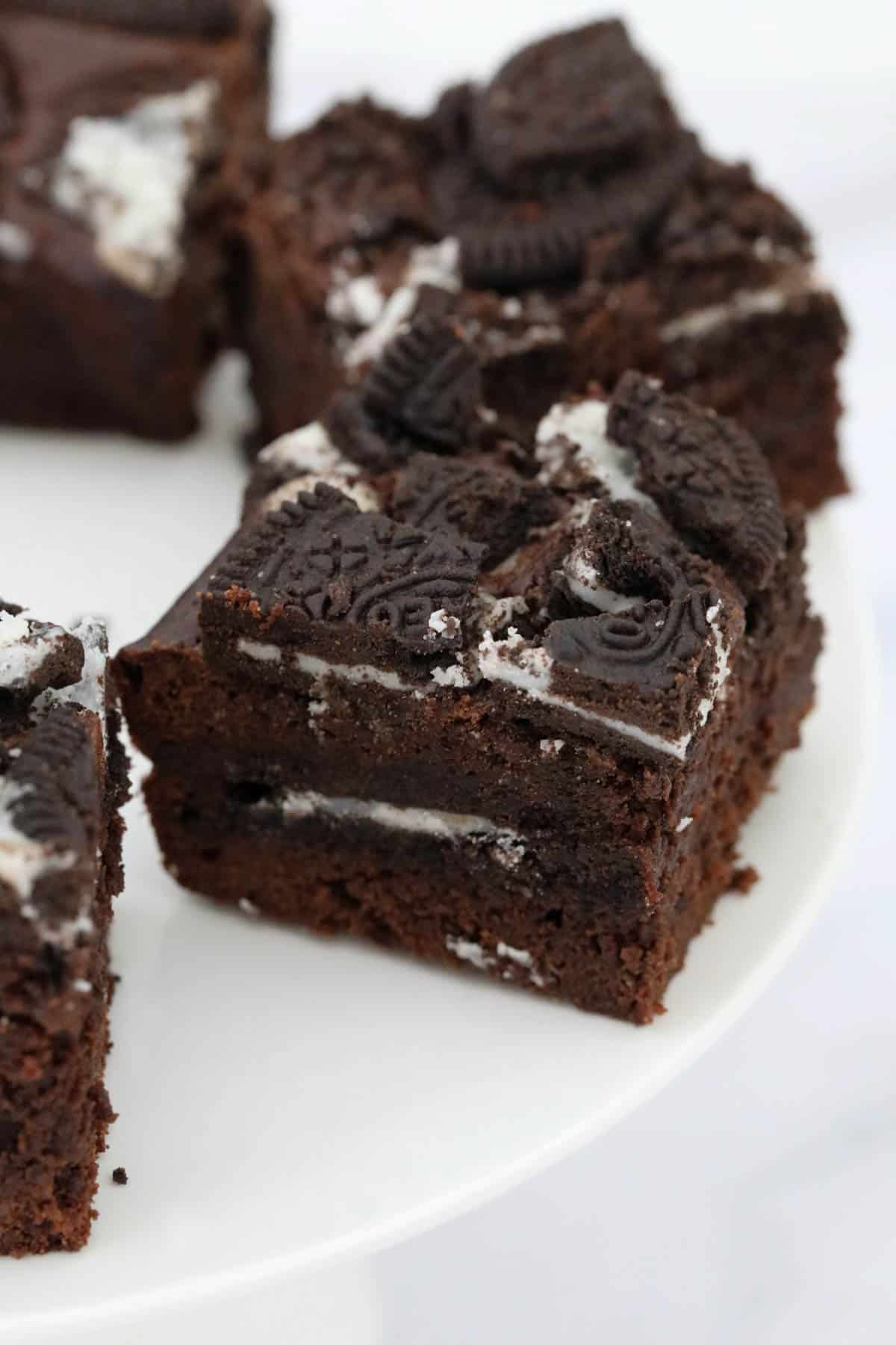 Oreo brownies on a white cake stand.