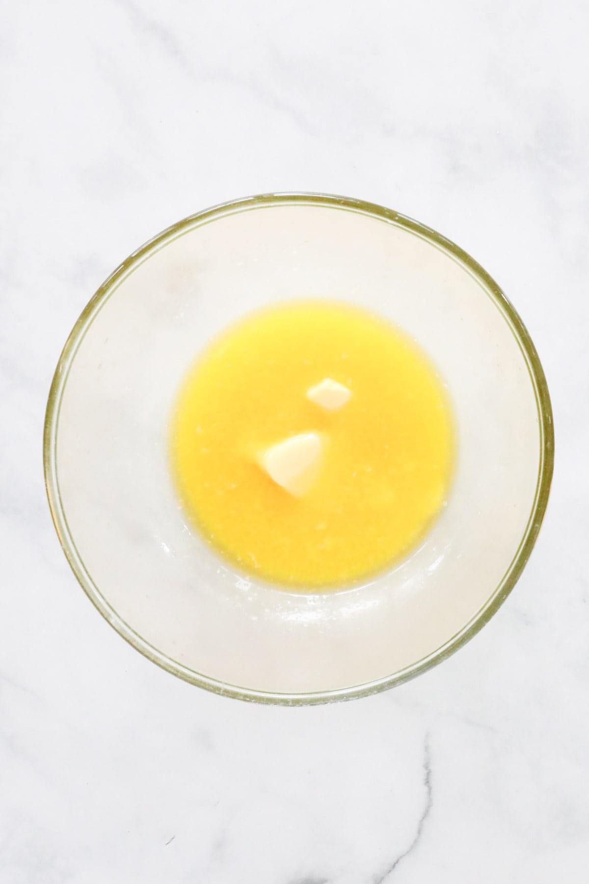 Melted butter in a heatproof glass mixing bowl.