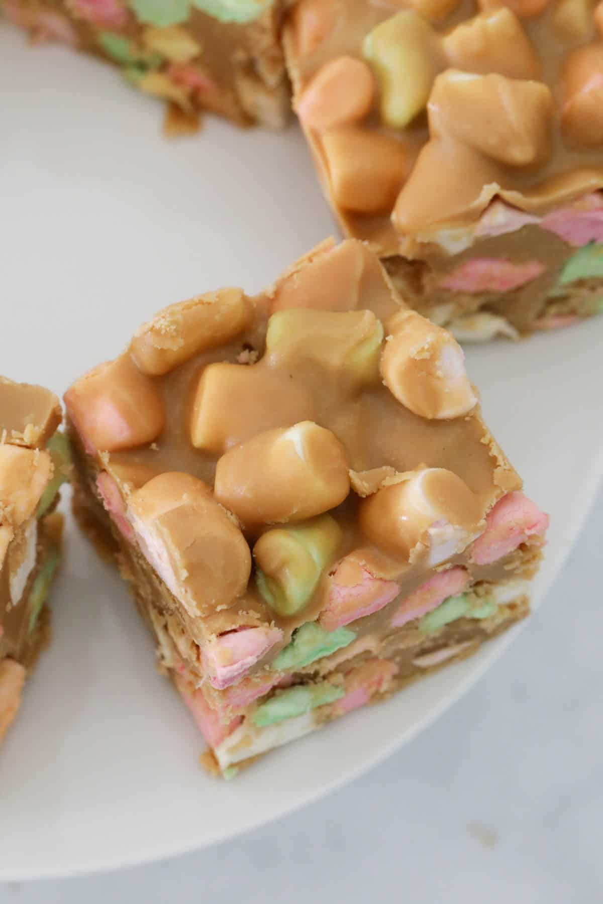 Top view of butterscotch marshmallow square on white plate.