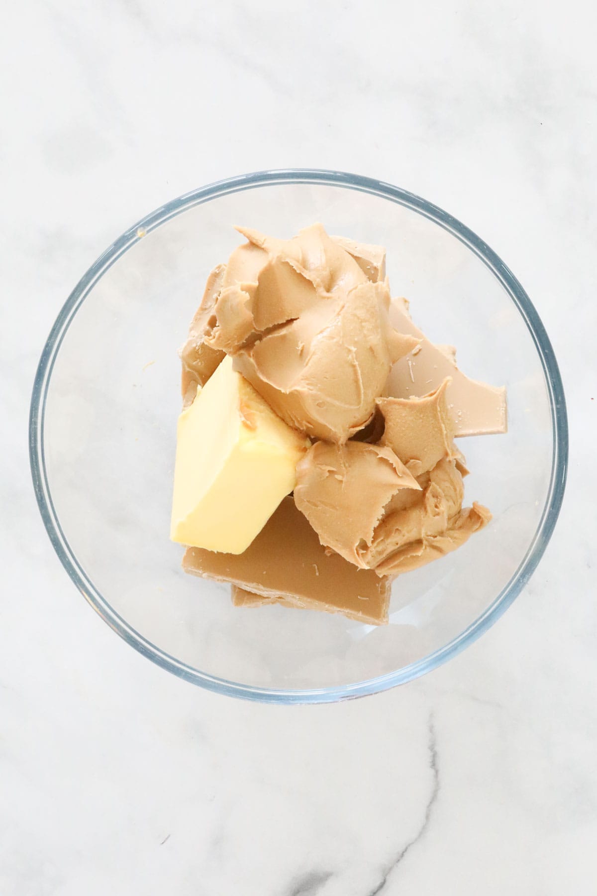 Butter, peanut butter and Caramilk chocolate in a heatproof bowl.