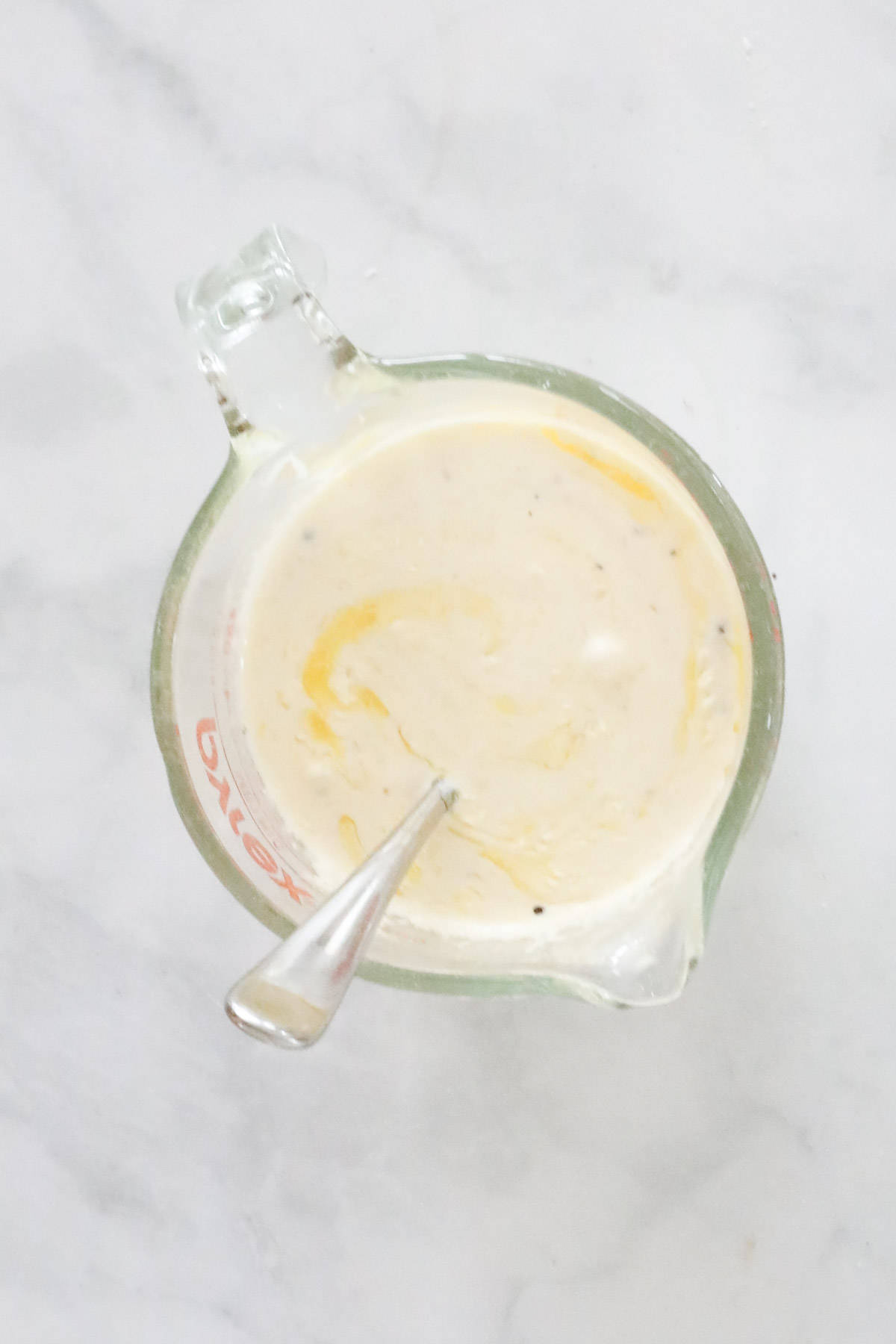 Cream, melted butter, garlic and seasonings whisked together in a jug.