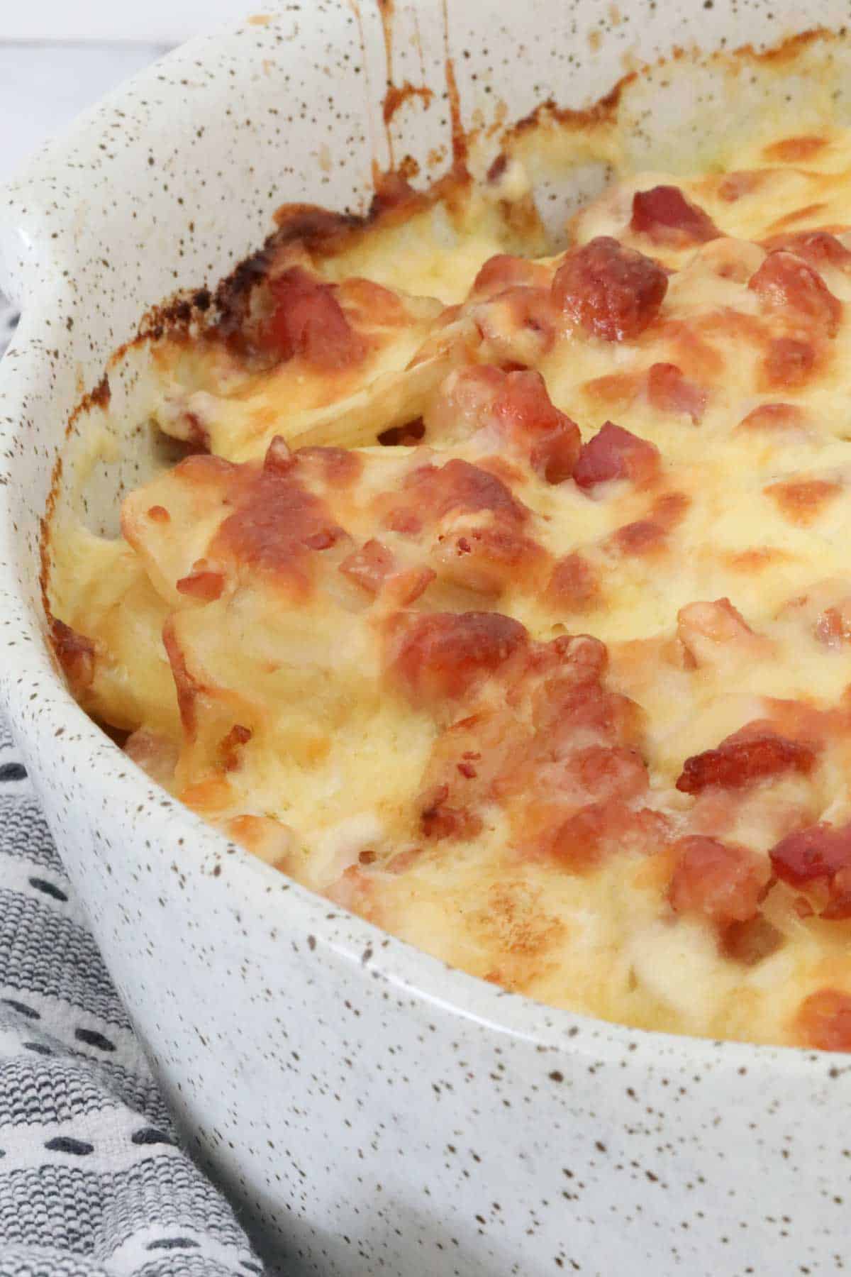 A dish of potato bake with a golden cheesy top.