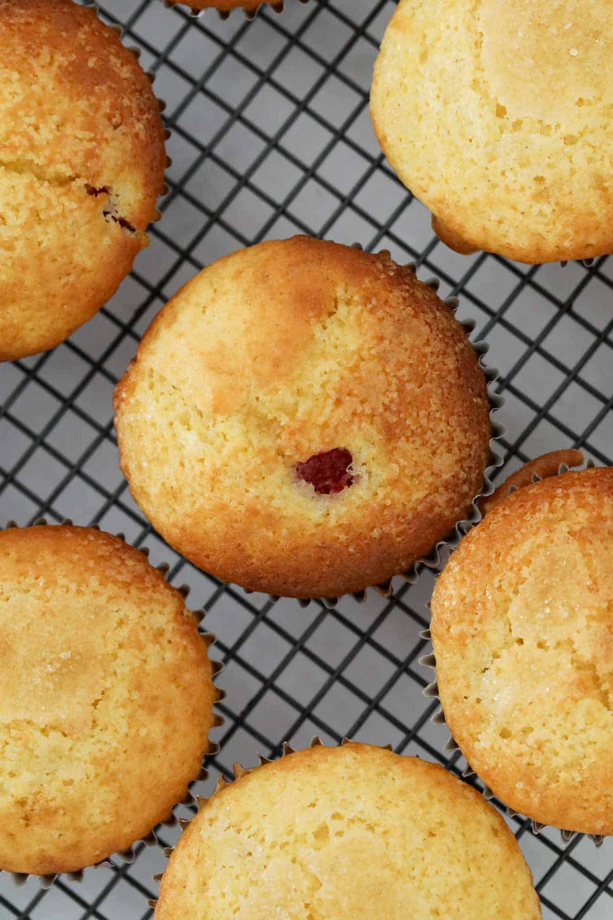 Looking down on muffins cooling on a wire rack.