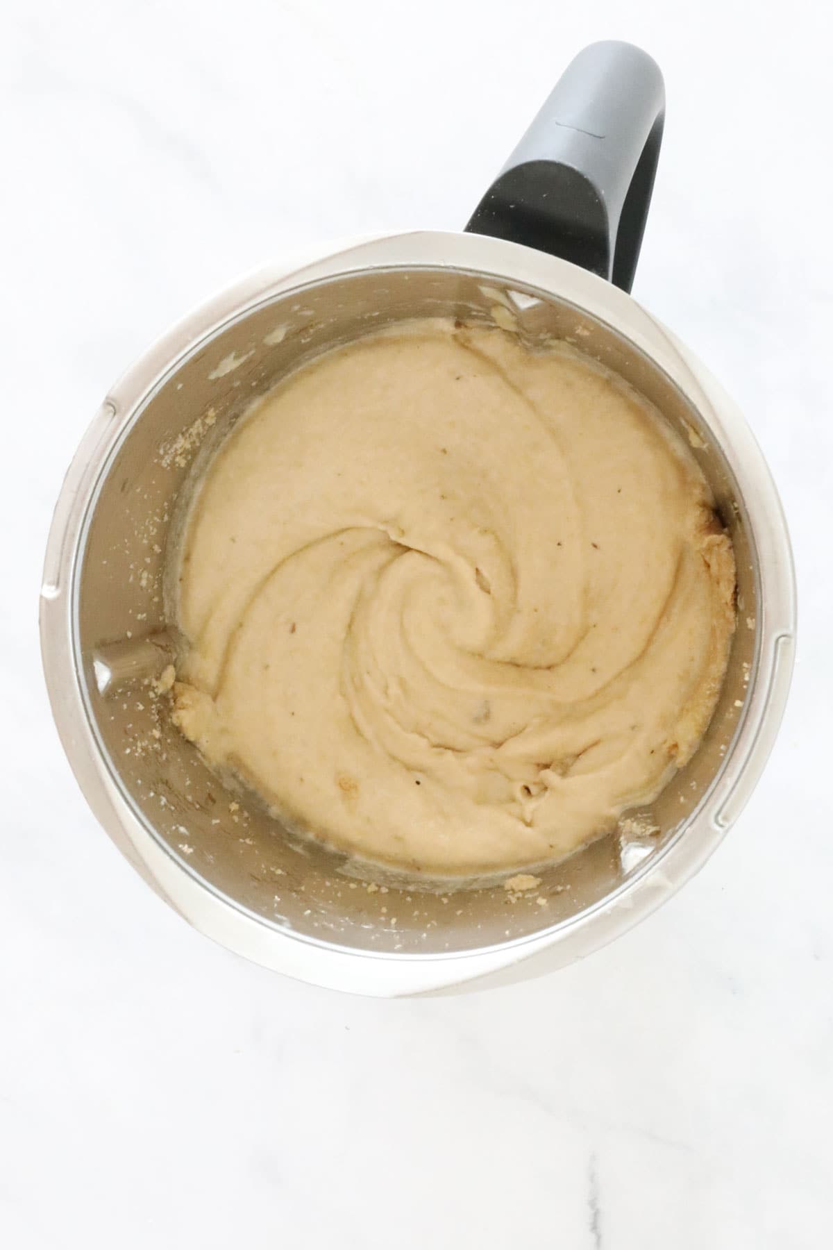 Creamy mixture in a Thermomix bowl.