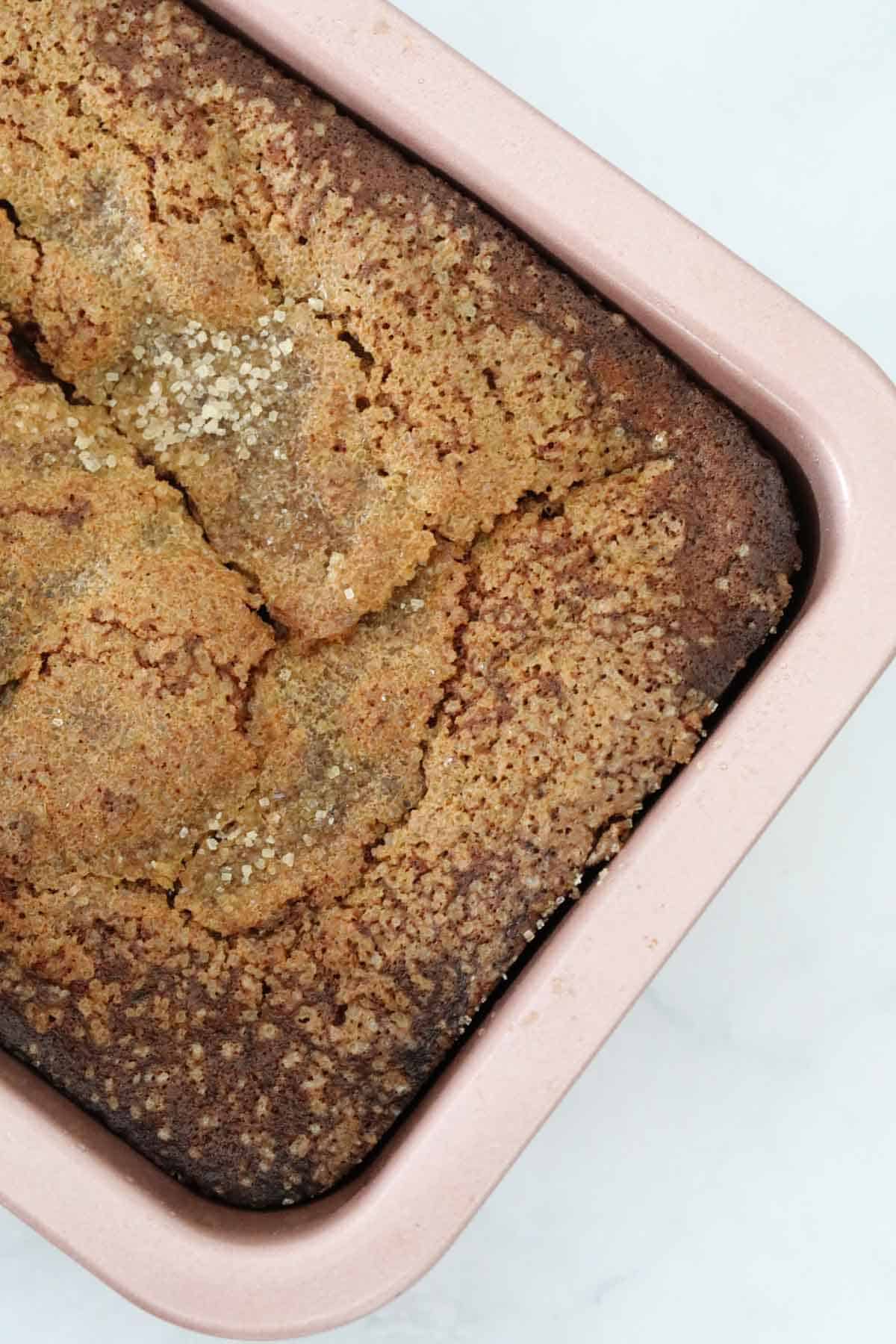 An overjead shot of a sweet banana loaf in a baking tin.