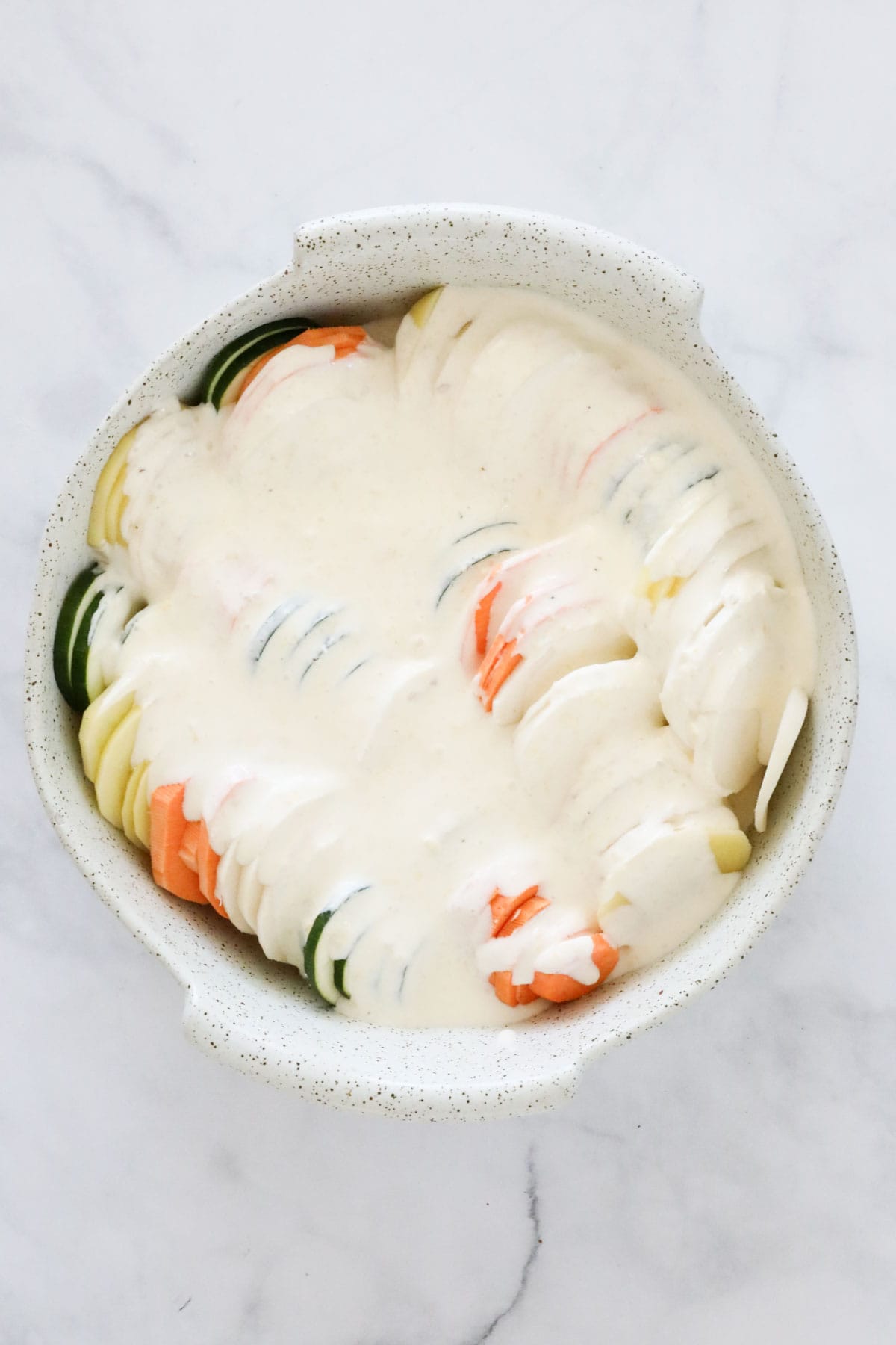 Cream mixture poured over the vegetables in baking dish.