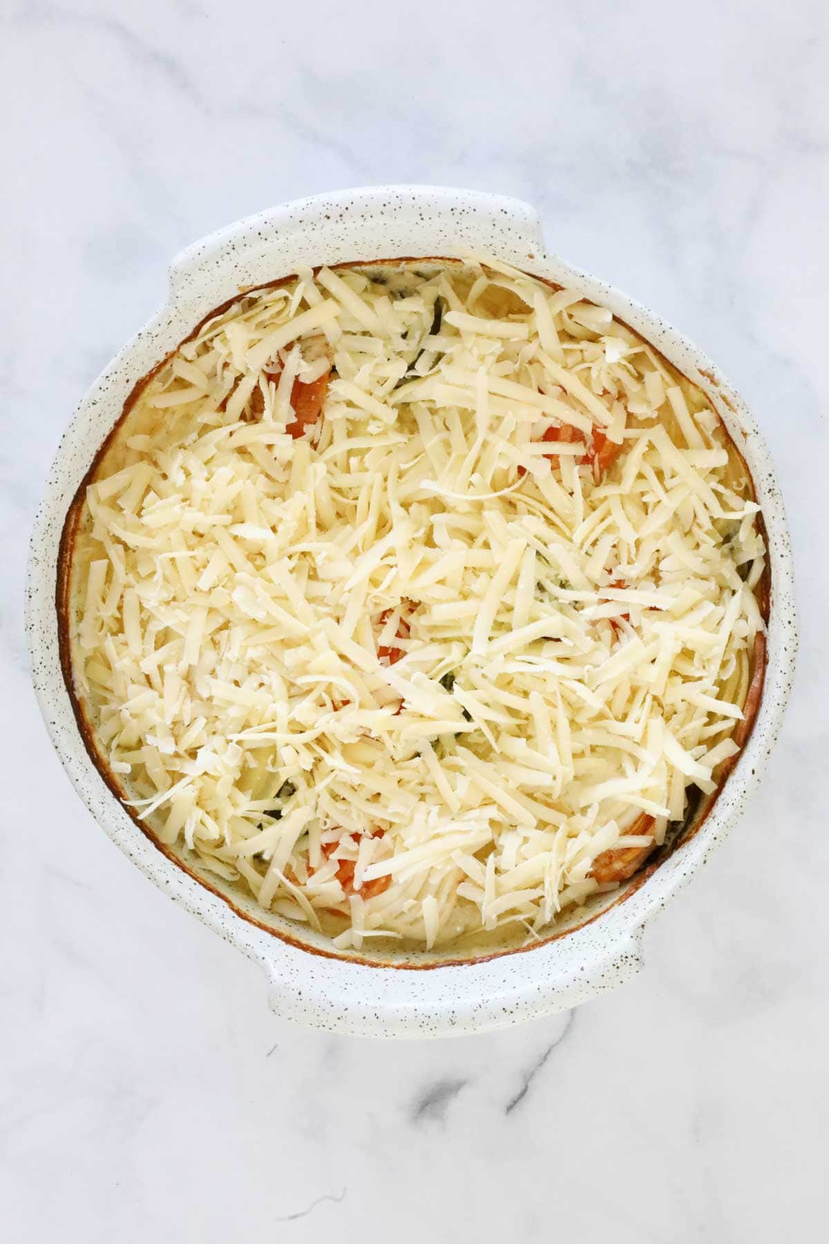 Grated cheese sprinkled over the vegetable bake.