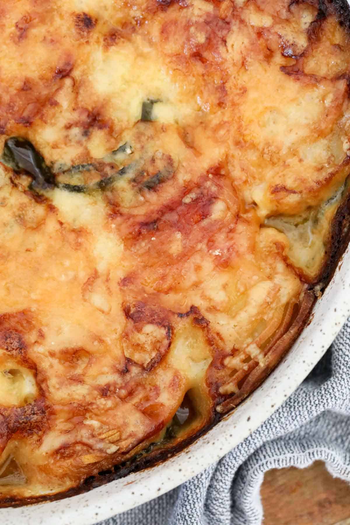 Close up of the baked vegetable with golden melted cheese on top.