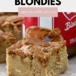 A square of dense and chewy blondie with chunks of Biscoff cookie on top.