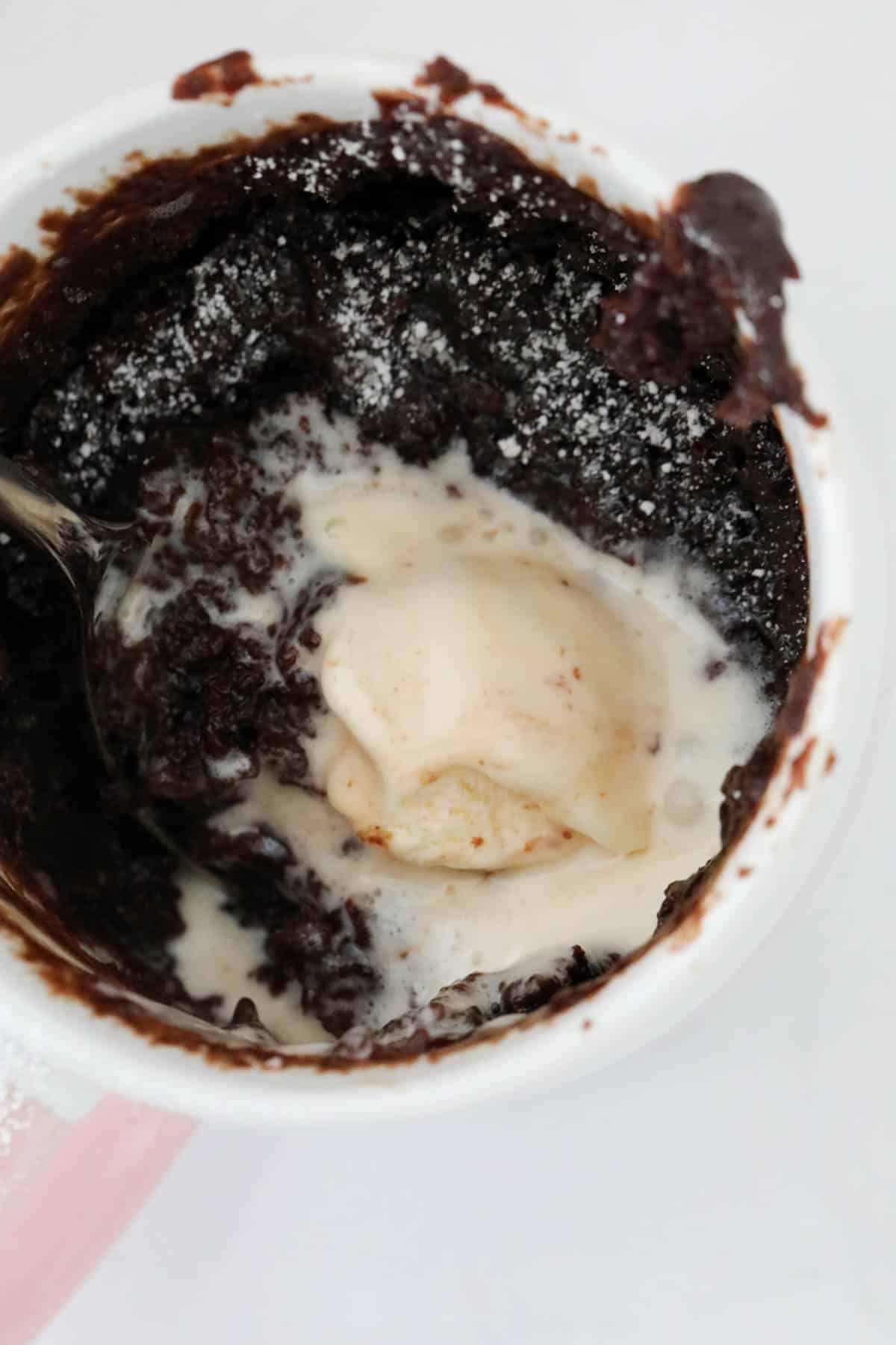 Ice cream melted into a chocolate mug cake.