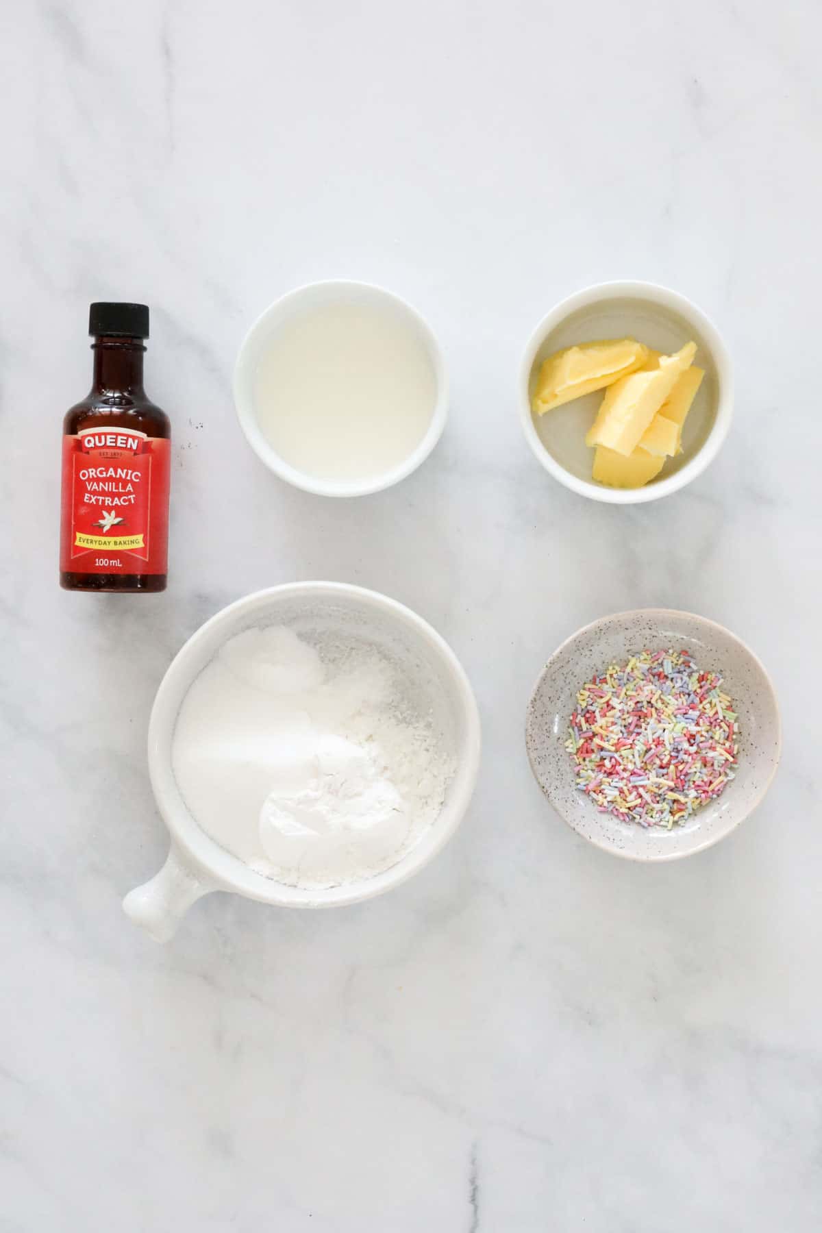 Ingredients required for vanilla mug cake on a bench.