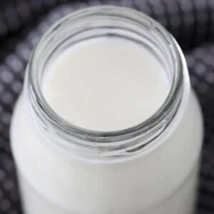 A glass jar filled with creamy buttermilk.