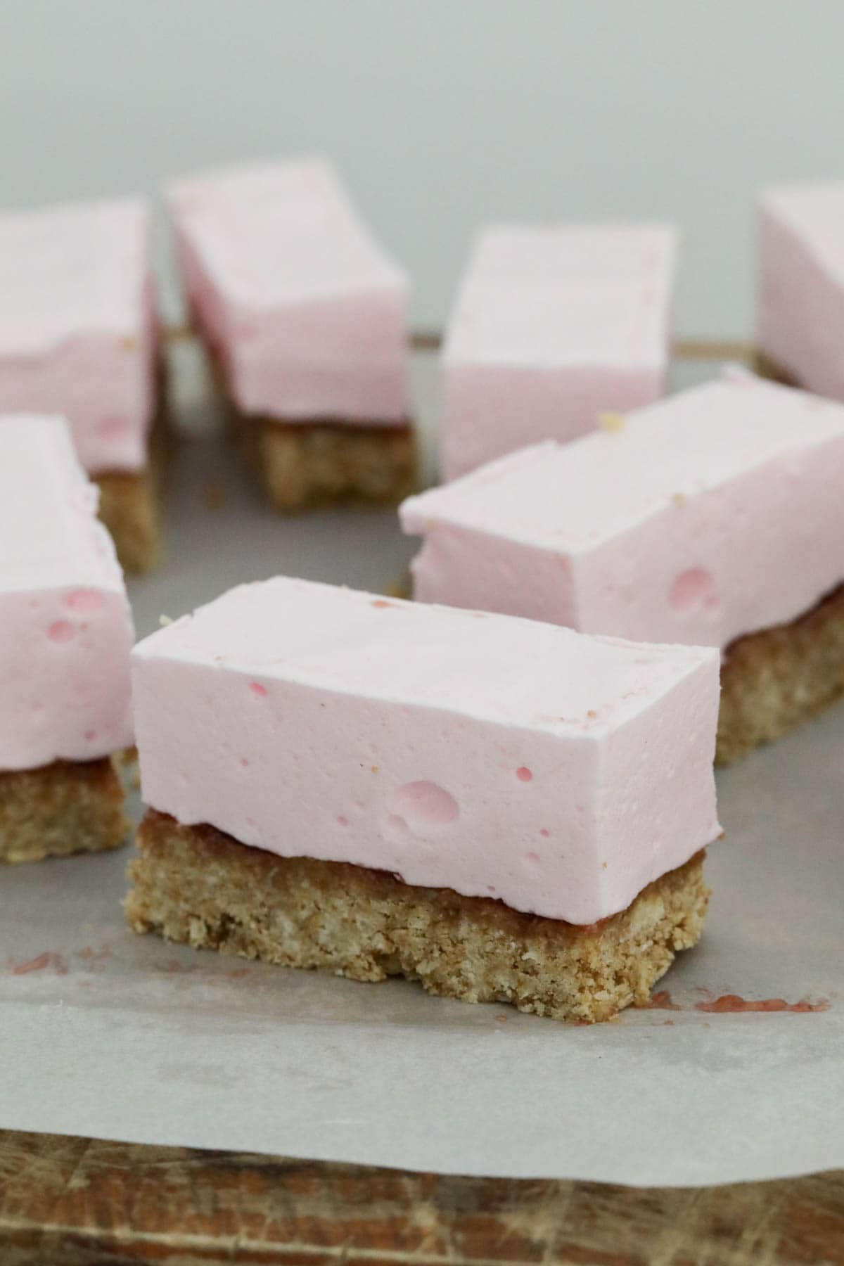 Close up of pieces of marshmallow slice on baking paper.