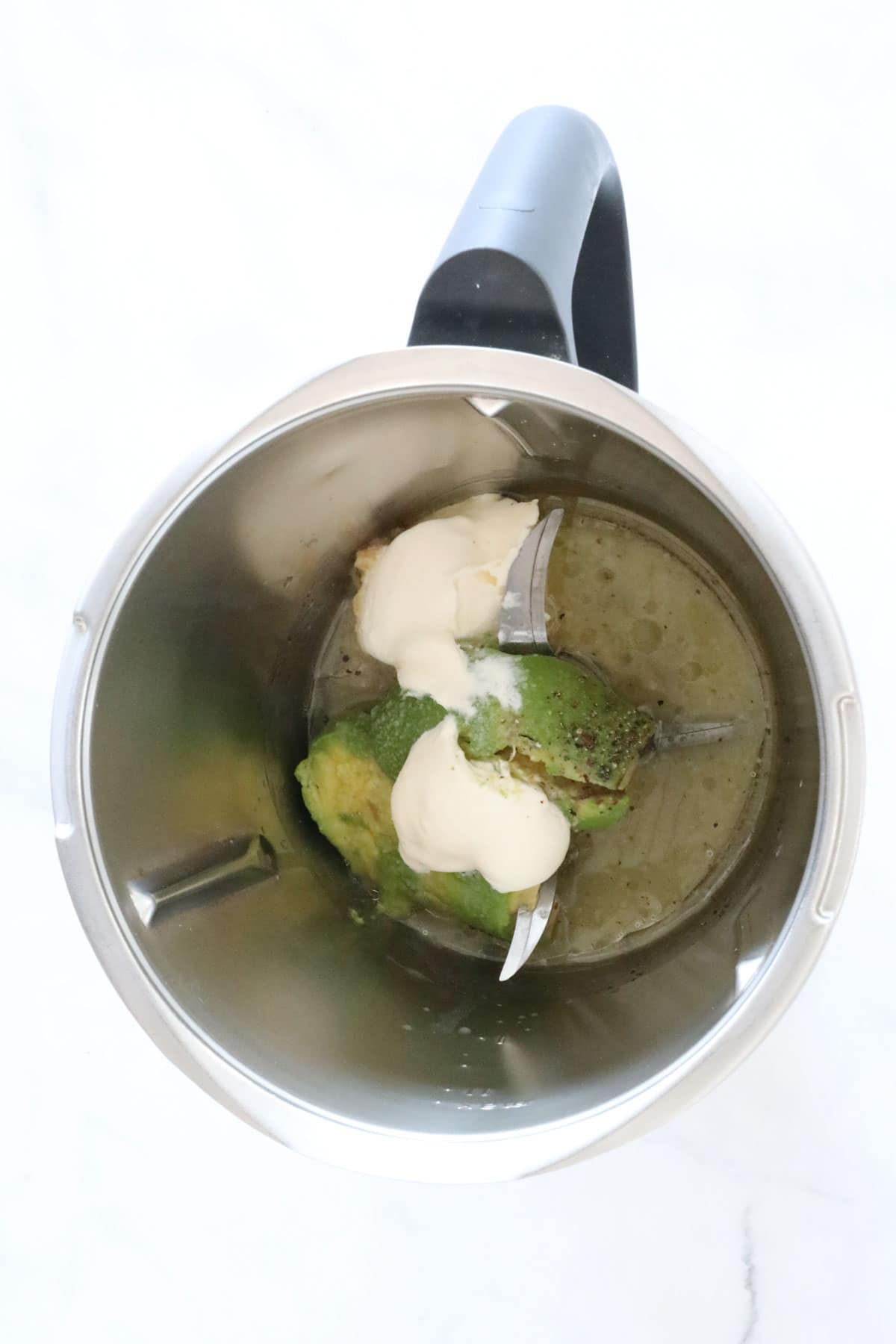 Avocado, lime juice and sour cream in a blender.