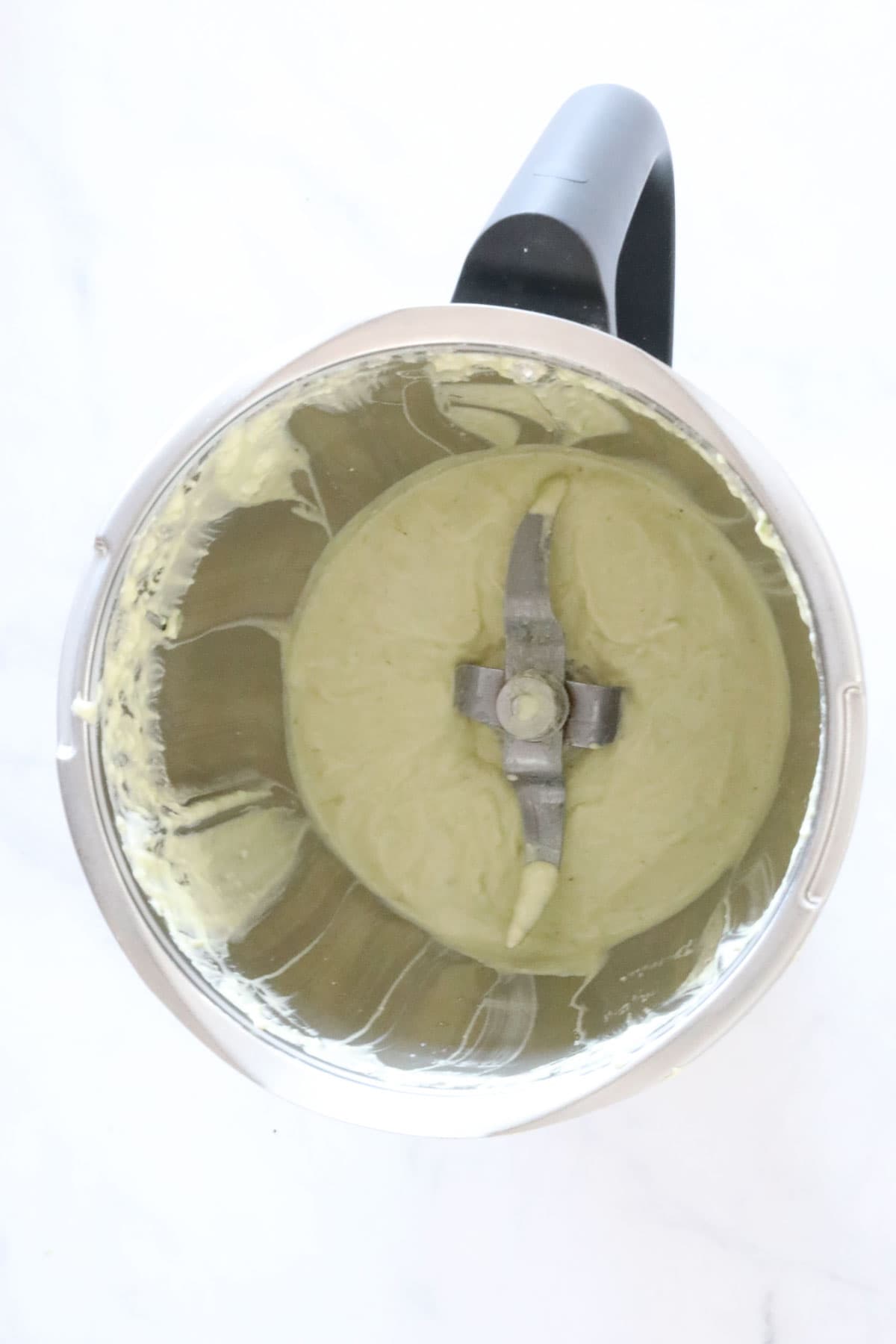 The blended creamy avocado salad dressing in the blender.