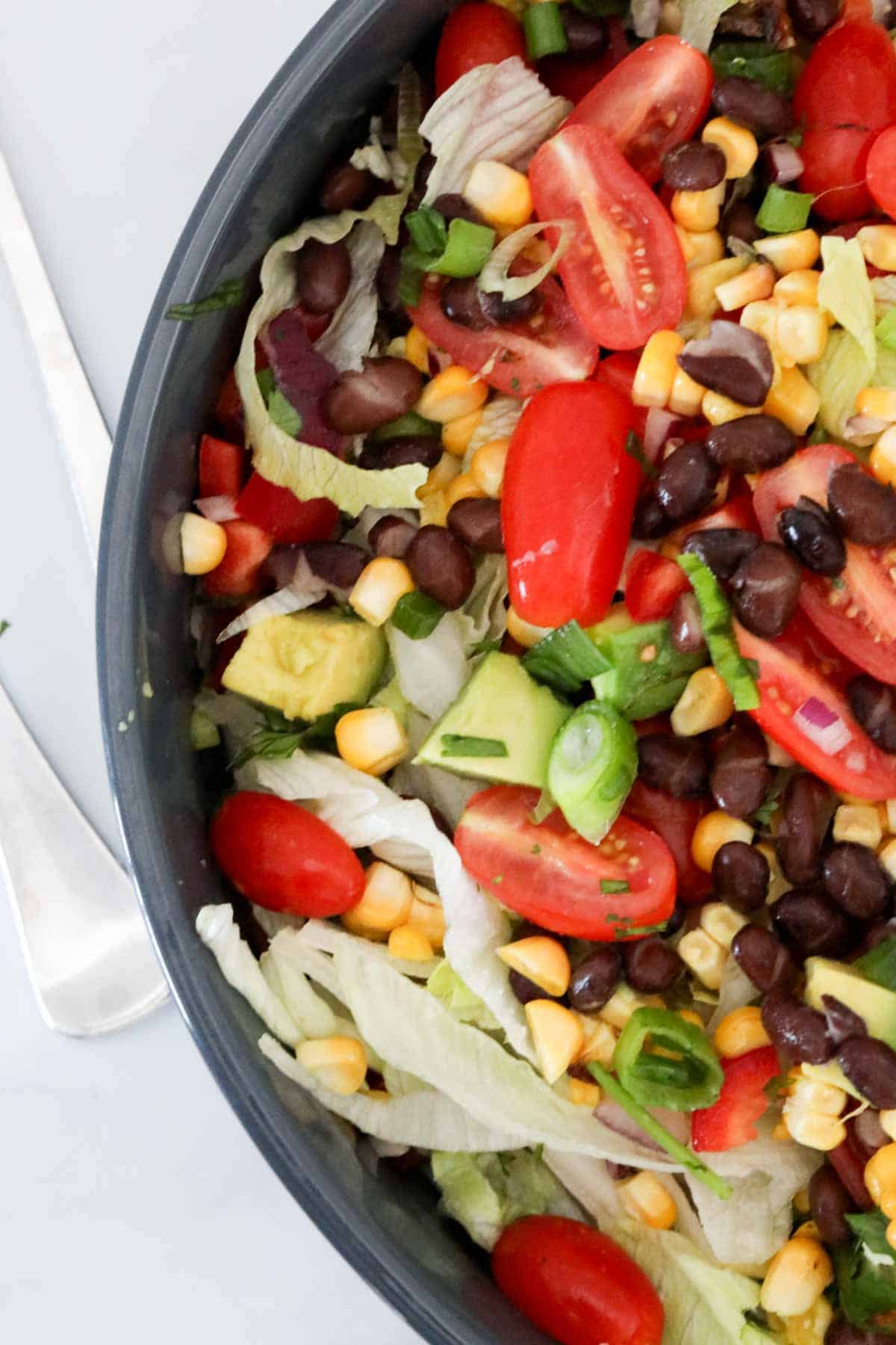 Overhead image of the chopped salad in a black salad bowl.