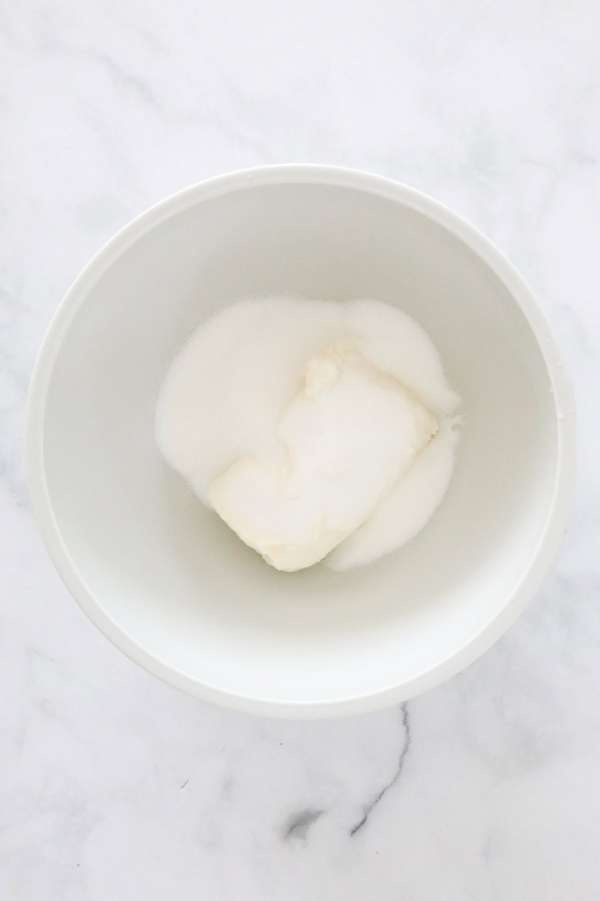 Softened cream cheese in a bowl with the caster sugar.