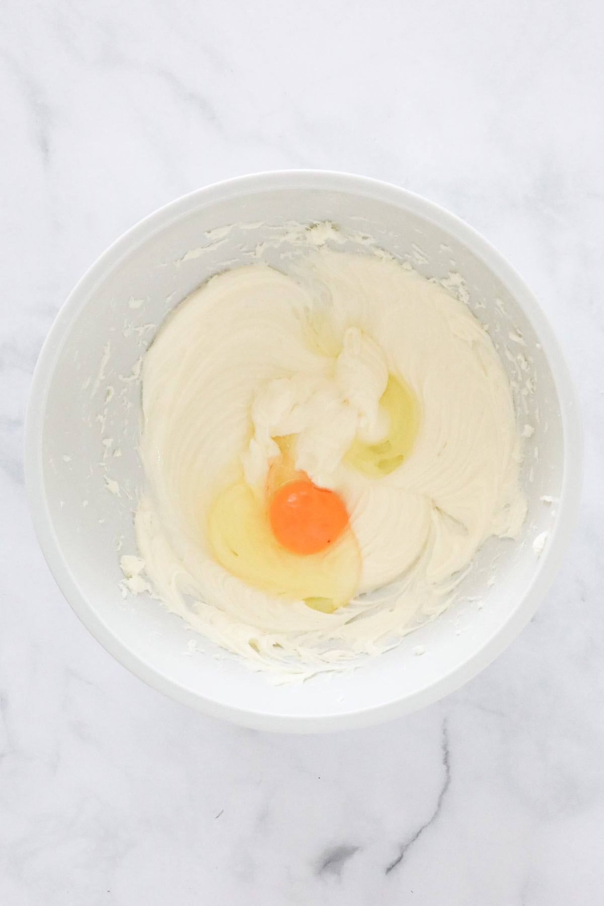 An egg and sour cream added to the cream cheese mixture.