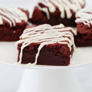 A rich and fudgy square of red velvet brownie drizzled with white chocolate.