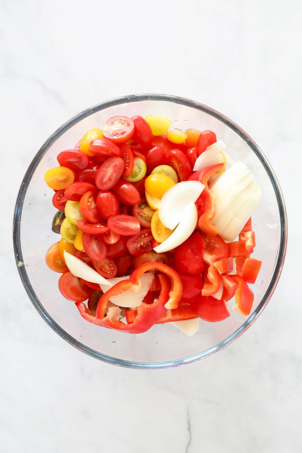 Chopped tomatoes, onions and capsicum in a bowl.