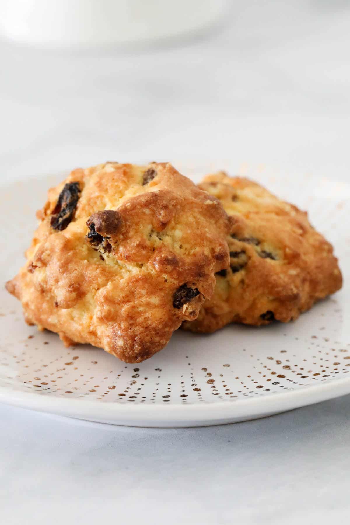 Two rock cakes on a white plate.